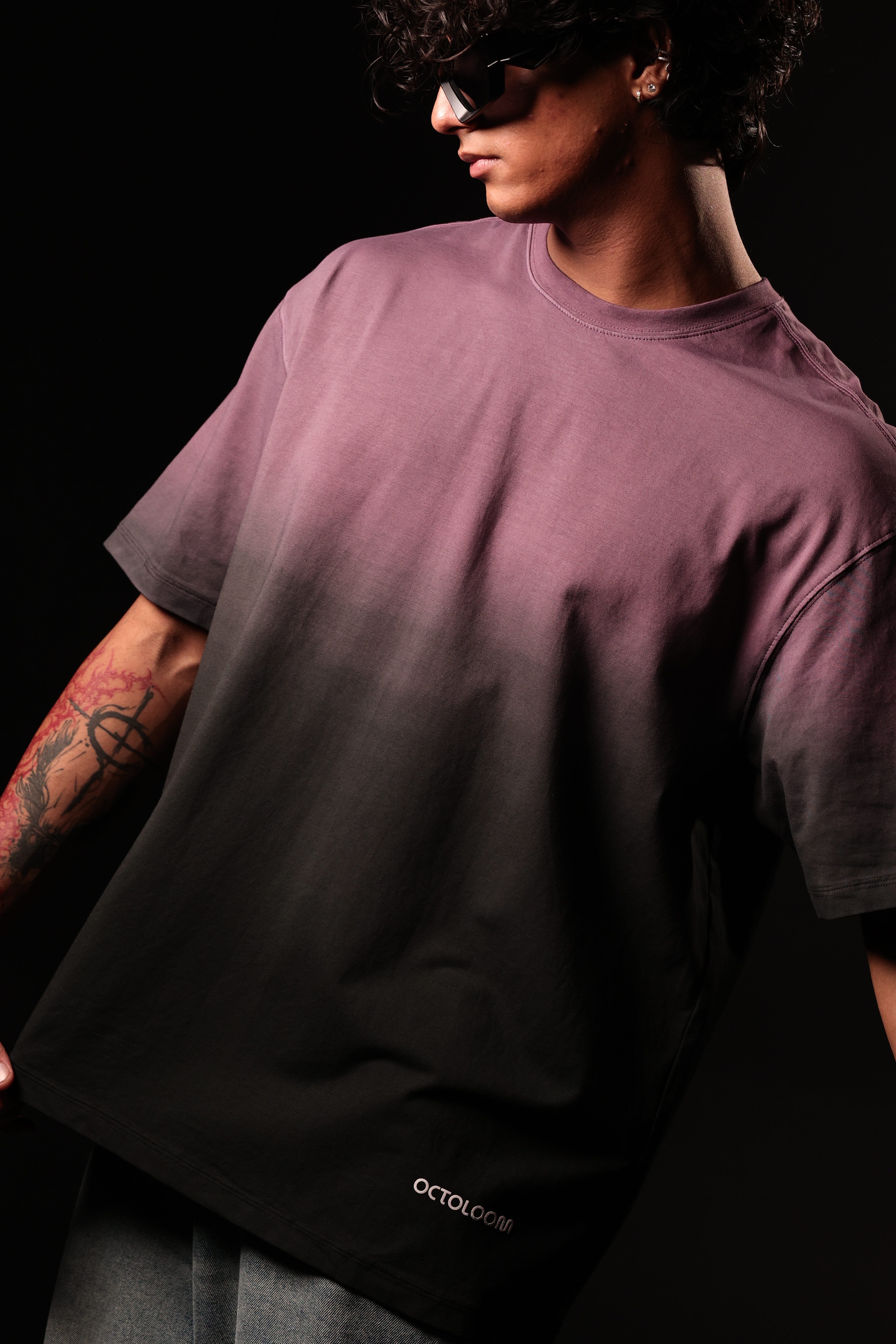 Person wearing a dark purple t-shirt with 'Octagon' branding on a black background