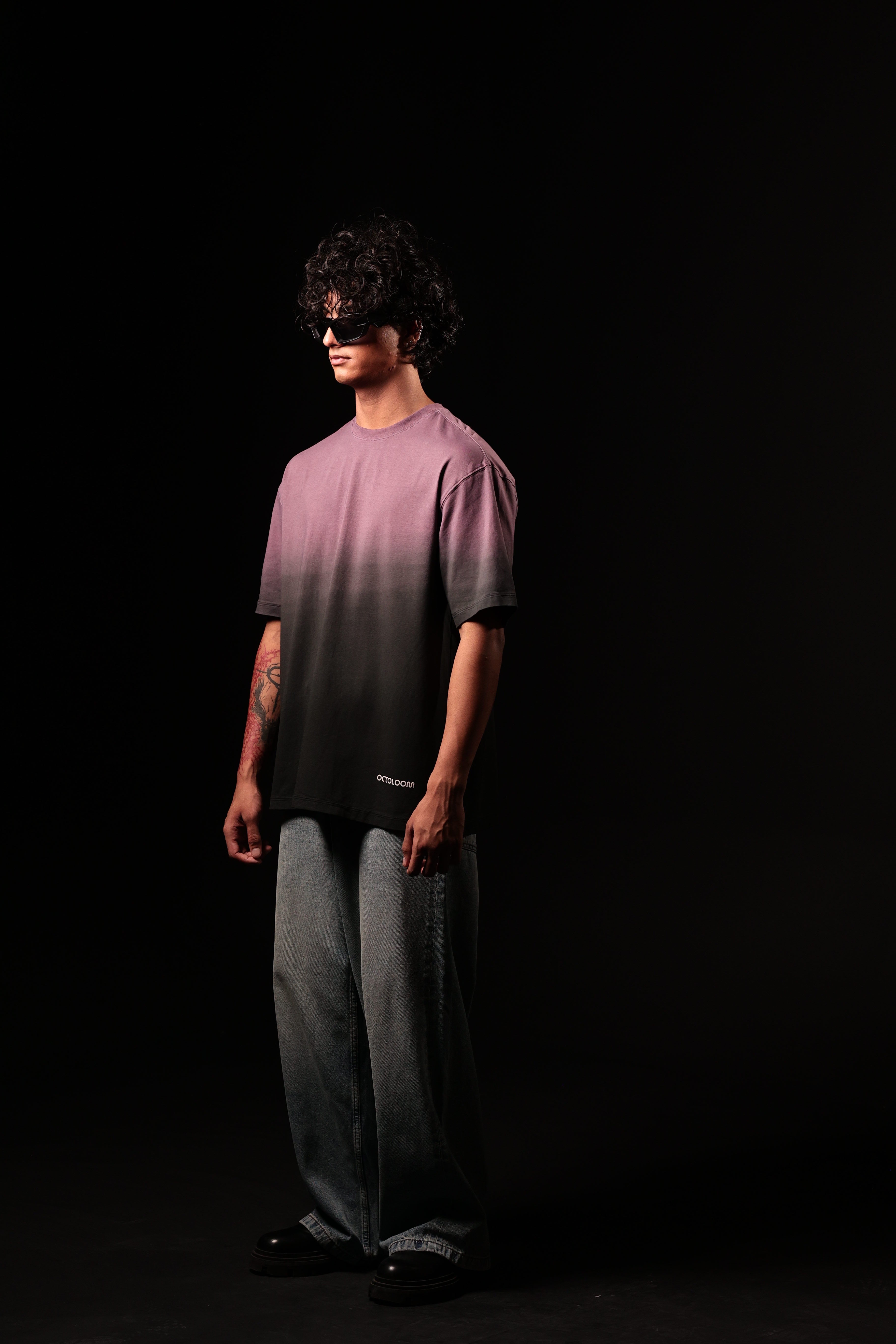 Person wearing a gradient t-shirt and pants on a black background