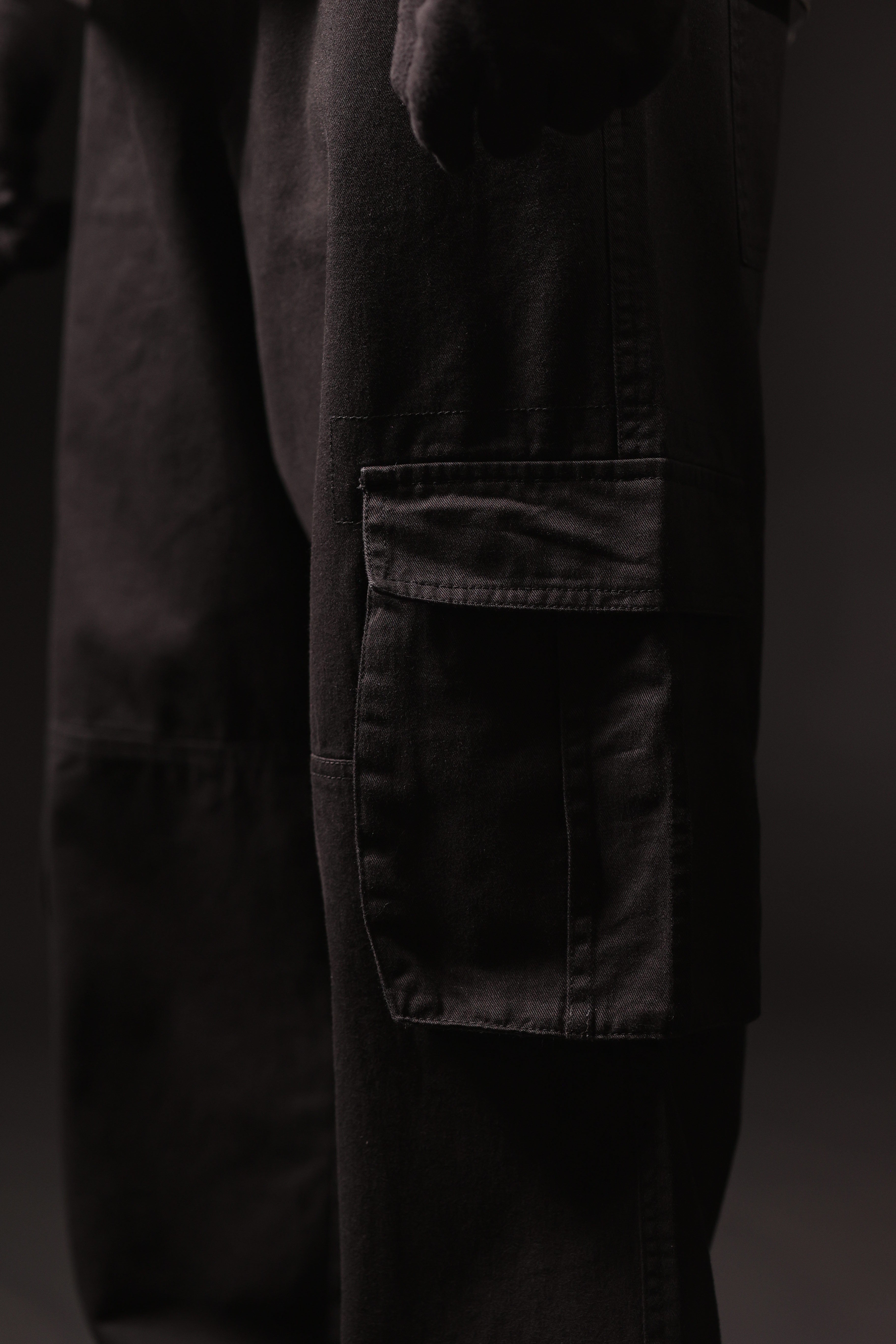 Dark pants with a pocket on a black background