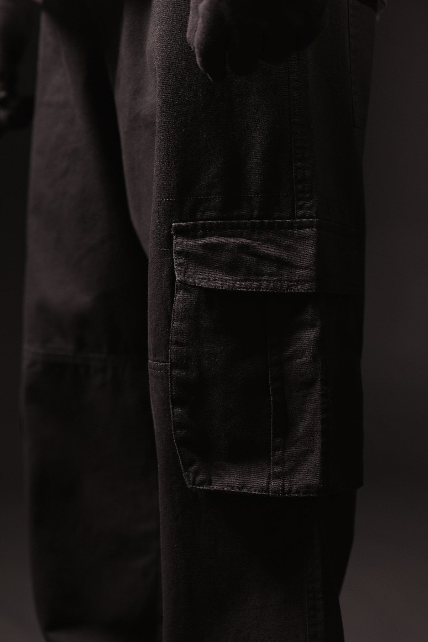 Dark pants with a pocket on a black background