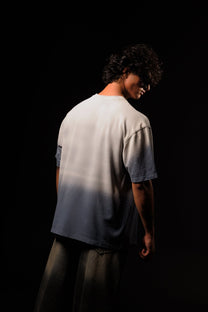 Person wearing a gradient t-shirt against a black background